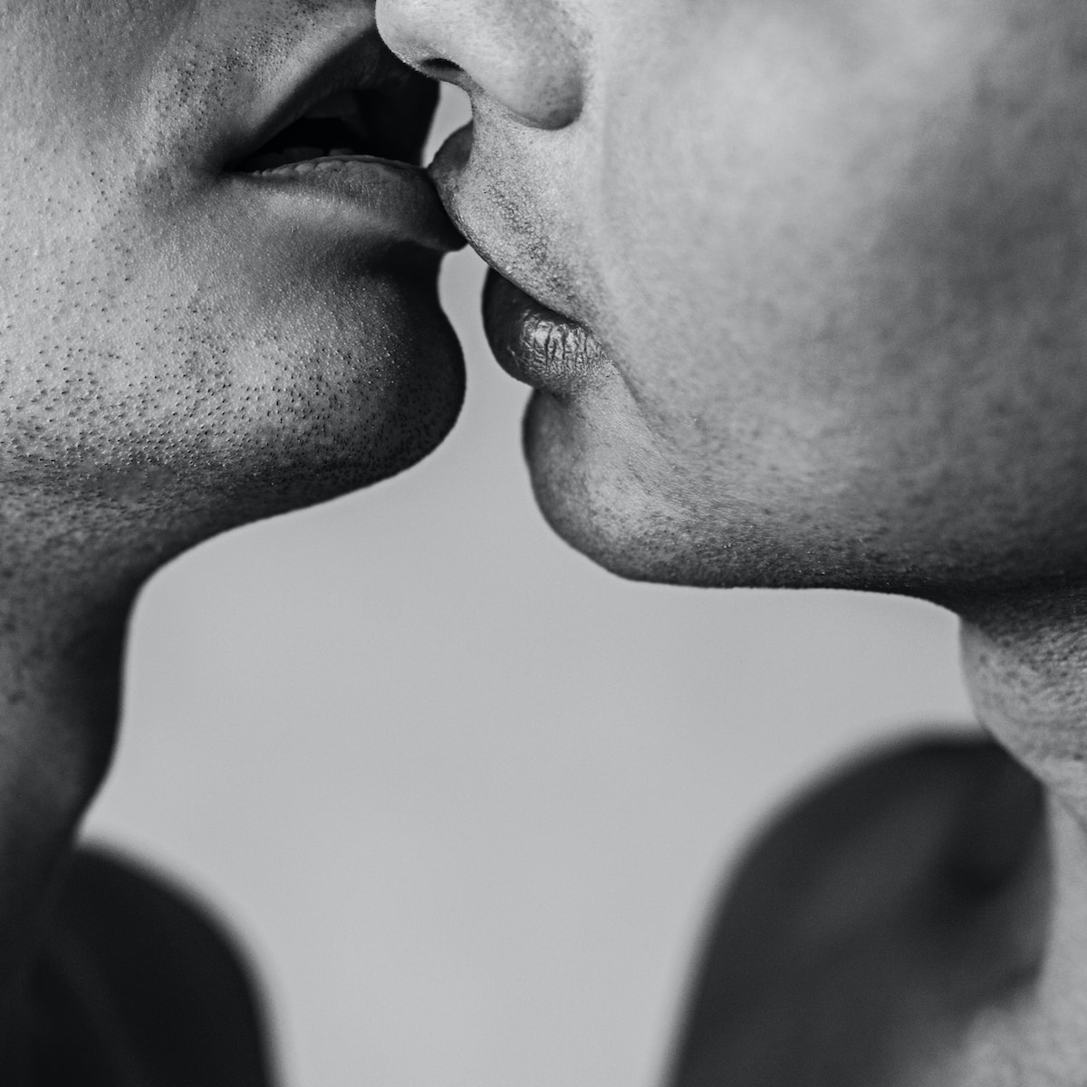 a man and a woman kissing each other